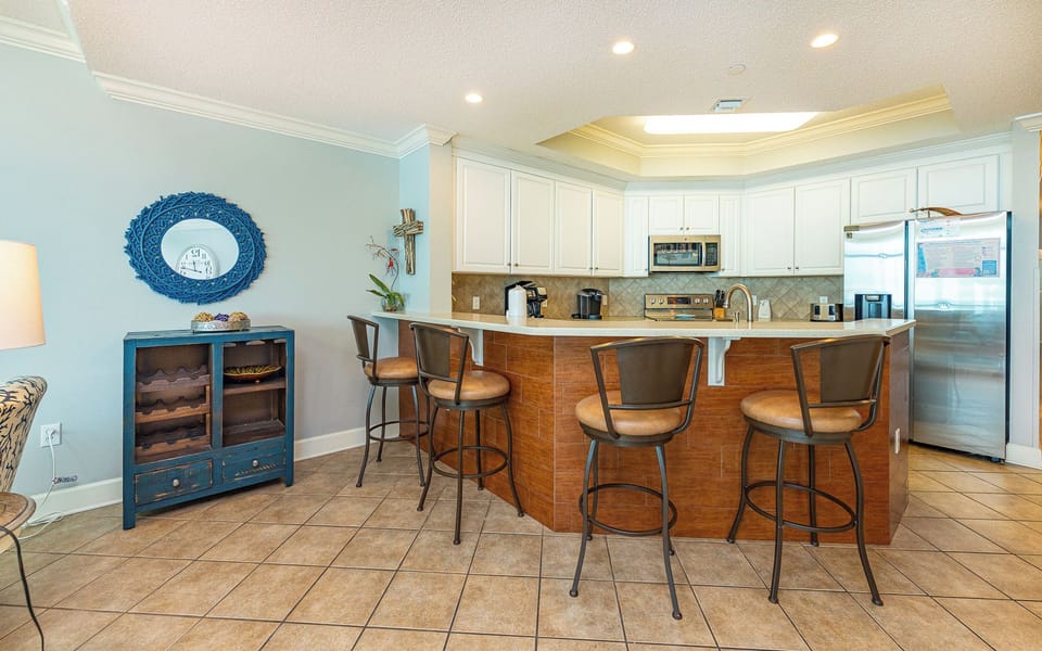 Gather around the breakfast bar in the kitchen where morning light brightens your start to the day