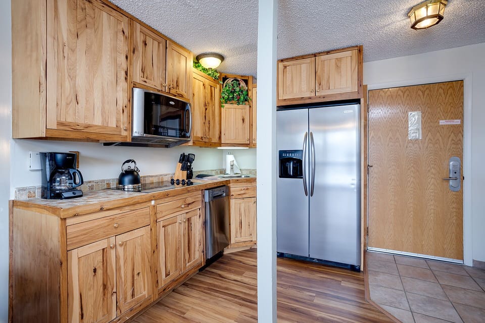 Step into your rustic-chic kitchen with warm wood cabinets, stainless steel appliances, and everything you need to create memorable meals during your mountain getaway.