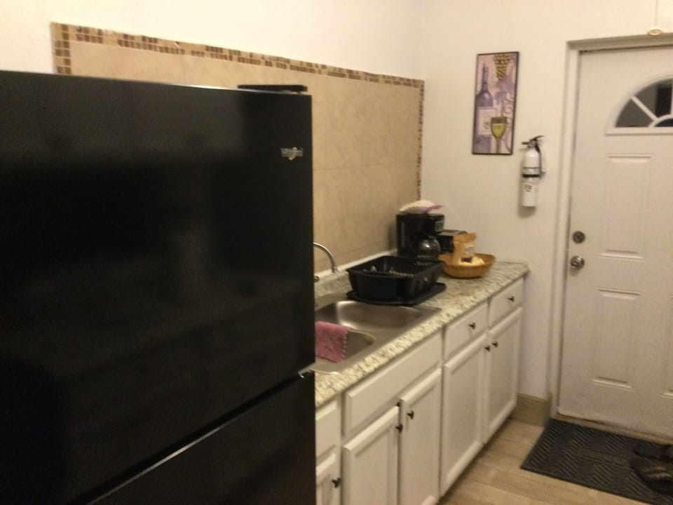 Photo of the kitchen from the dining room showing hot beverage items.
