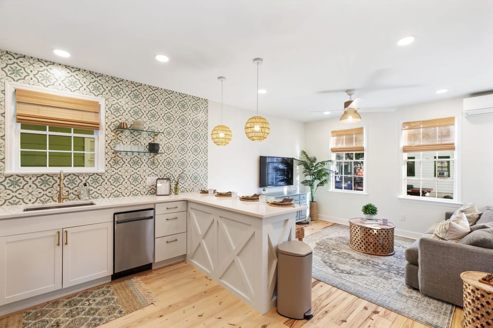 Bright and inviting kitchen/living room combo. Smart TV.  Crate and Barrel sofa