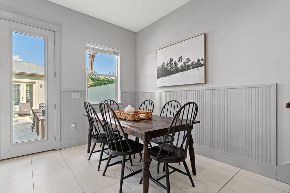 Downstairs dining table with view of outside patio and pool