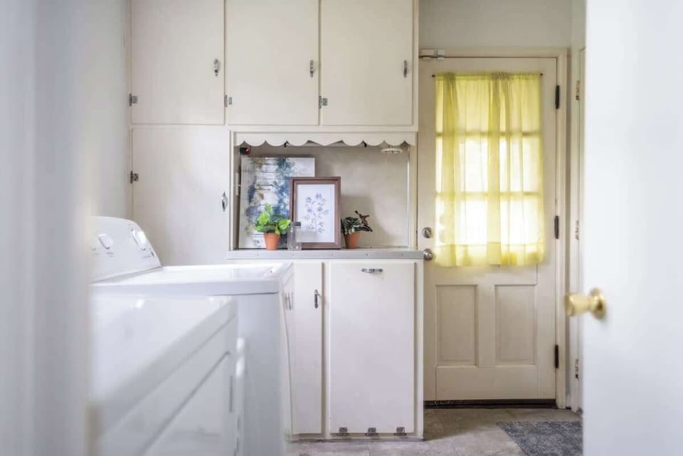 - Laundry area with washer and dryer for guest use   - Airbnb home offers convenience with storage space   - Bright details and decor add charm to utility room  