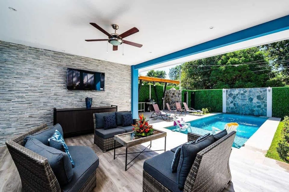 Savor poolside moments surrounded by lush greenery.