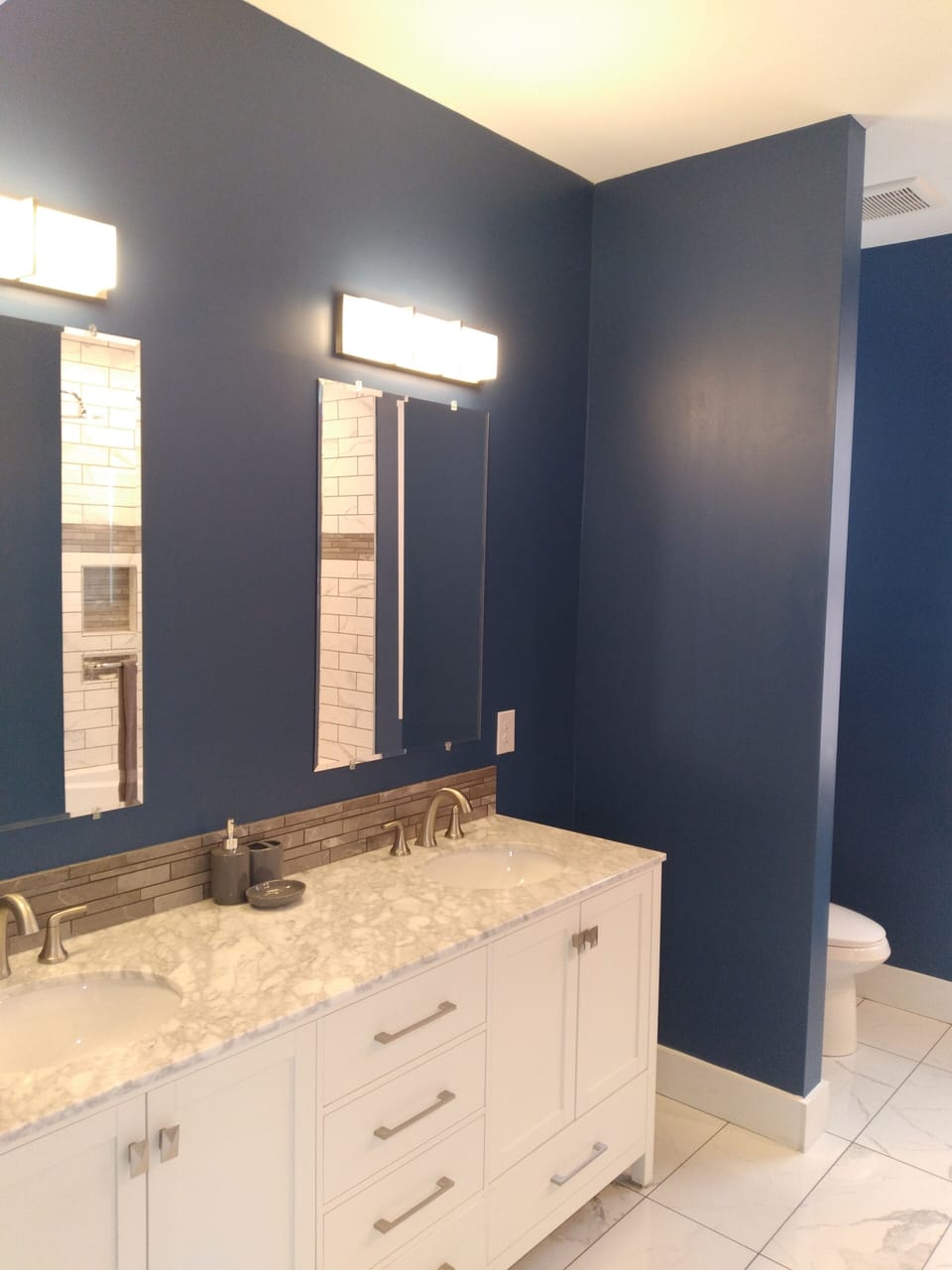 En suite master bathroom with double-bowl vanity.