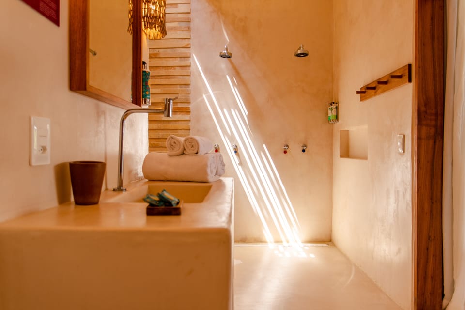 Suite Pool View | Bathroom | Shower, rainfall showerhead, designer toiletries, hair dryer