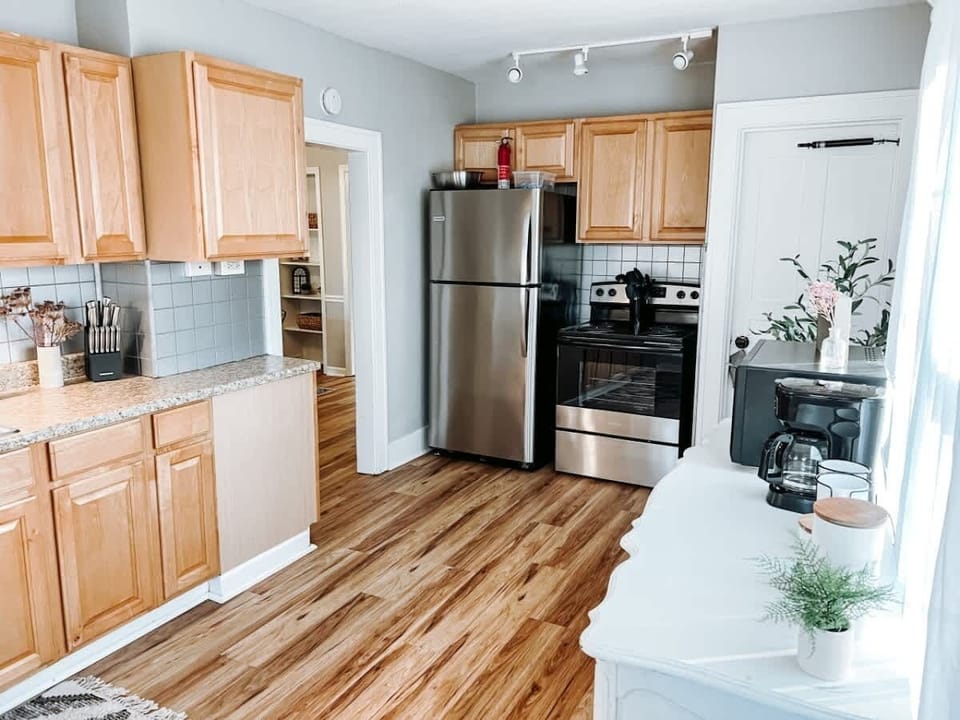 - Fully equipped kitchen with stainless steel appliances   - Wooden cabinetry with ample counter space for cooking   - Modern setup ready for home-cooked meals and dining  