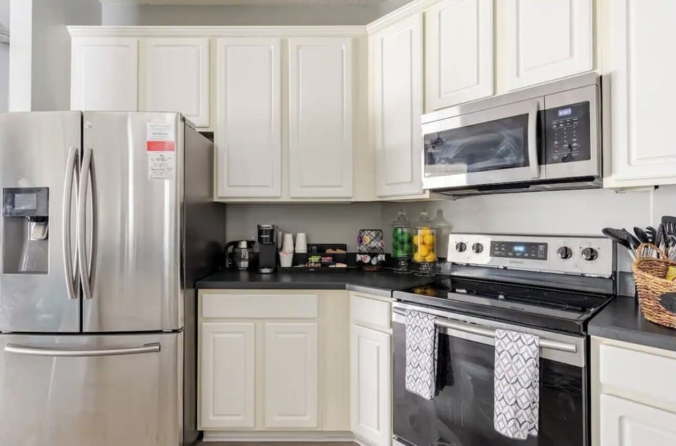 Modern kitchen featuring stainless steel appliances and everything you need for a comfortable, home-style cooking experience.