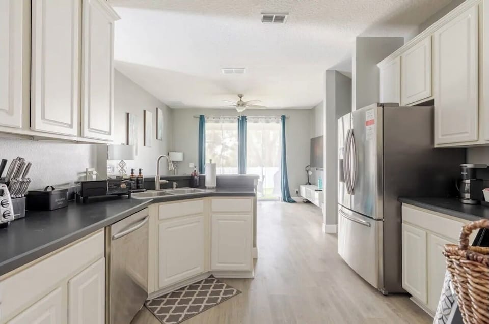 Fully equipped kitchen with sleek countertops and ample space—perfect for preparing meals, morning coffee, or late-night snacks.
