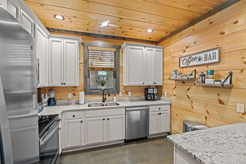 Well-stocked kitchen has stainless steel appliances and granite countertops.