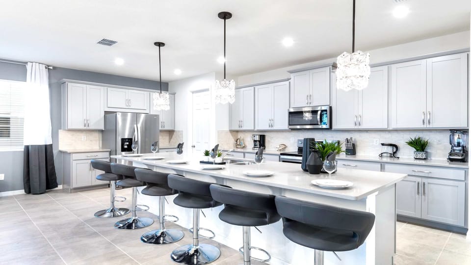 Modern gourmet kitchen with island seating and elegant lighting!