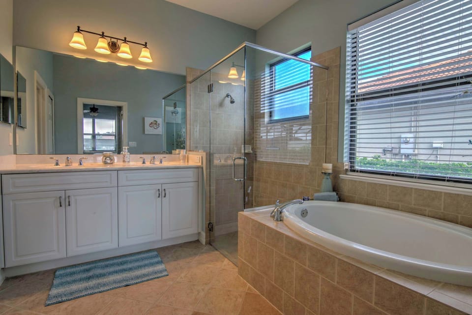 The Attached En Suite Bathroom Has a Glass Enclosed Shower and a Soaking Tub