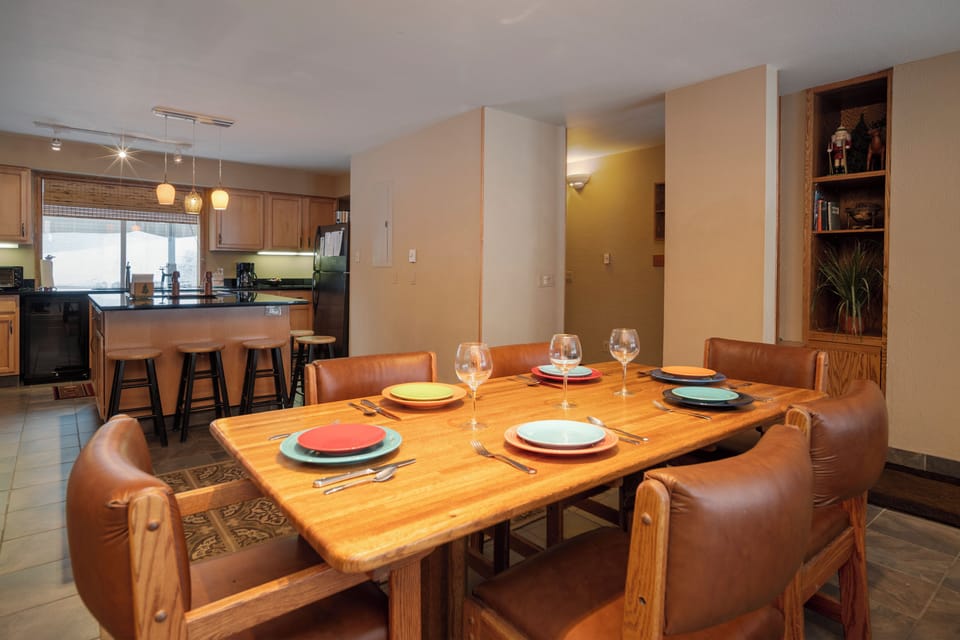 Gather around your beautifully set dining table where warm leather seating invites memorable meals with loved ones in this open, welcoming space.