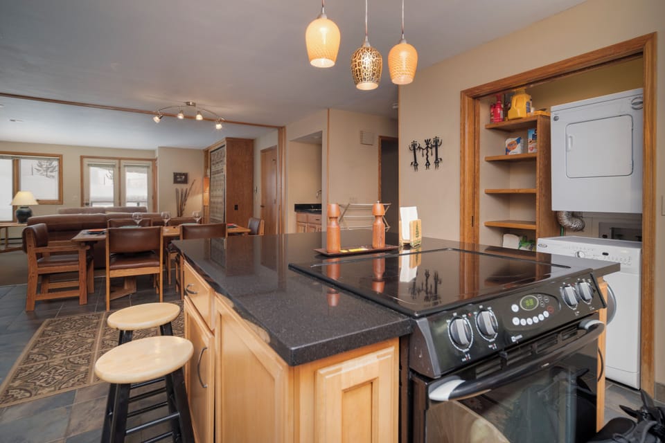 Your modern kitchen features gleaming granite countertops, stainless appliances, and warm pendant lighting for perfect meal preparation.