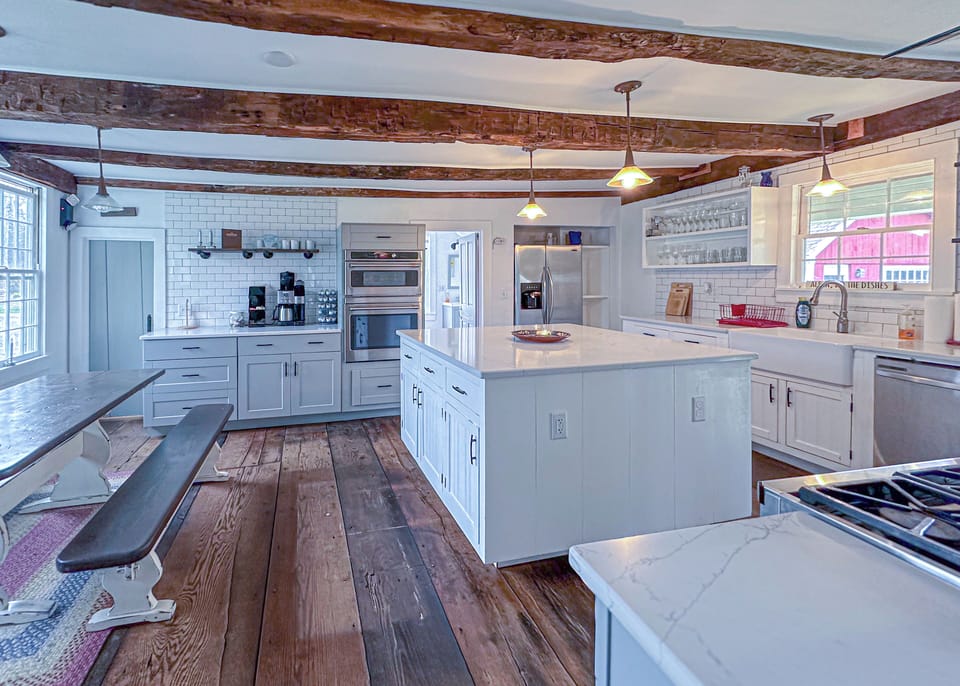 Step into a space where light dances across white subway tiles and rustic.