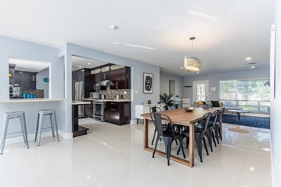 Cook, dine, and unwind in this sleek open-concept space with modern kitchen, stylish dining, and cozy living. A standout Airbnb vacation rental—perfect for shared meals, relaxed evenings, and effortless comfort.