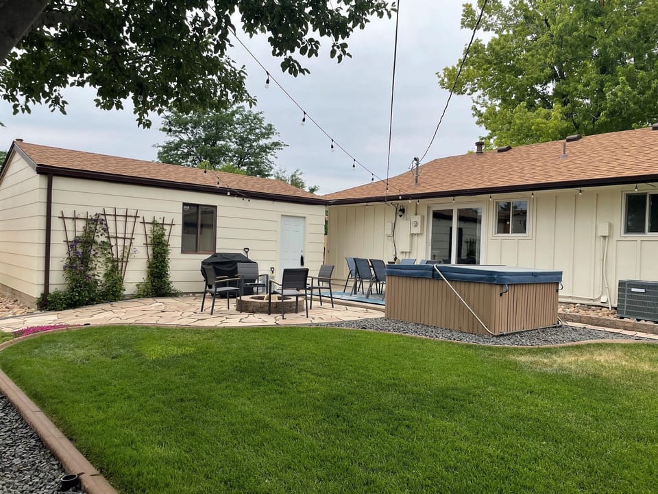 Spacious backyard with hot tub, fire pit, and patio entertainment.