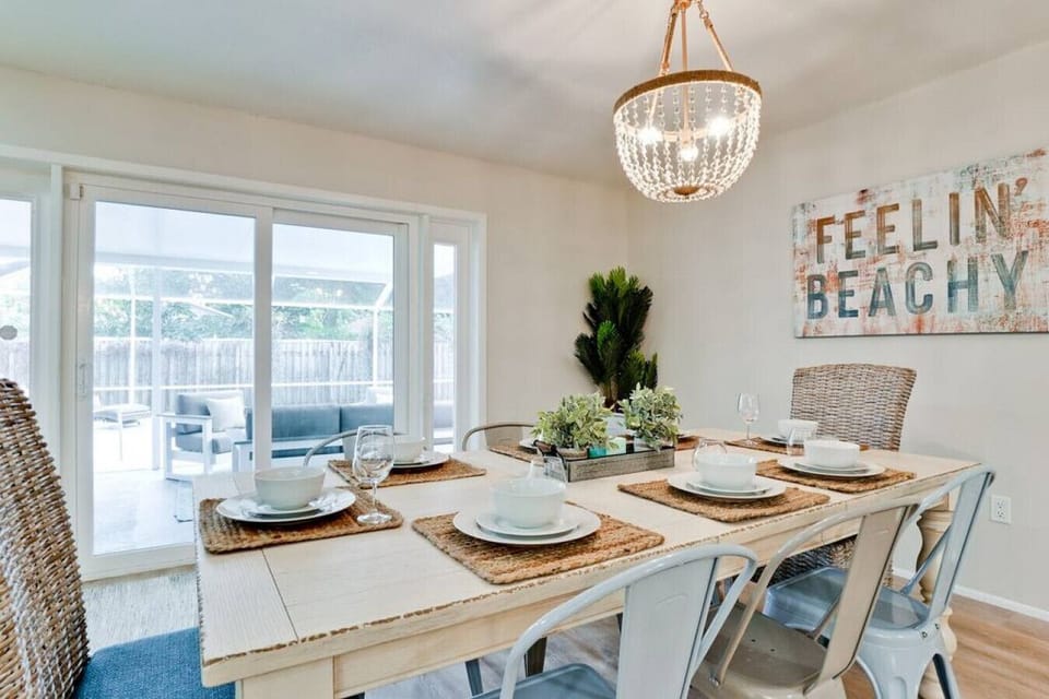 Dining area with lots of natural light from pool area. Seating for 8 + bar area in kitchen and table outside for 10! :)