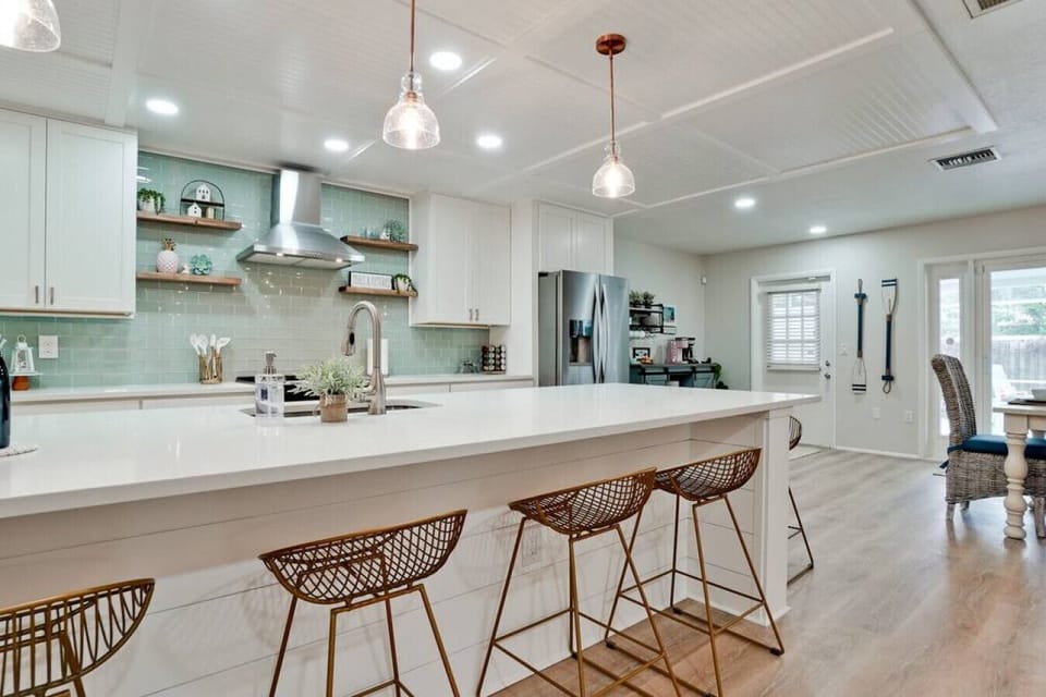 Huge island with ample room for 6 + to gather and hang out.  Gorgeous quartz counters. Quality cabinets with soft close drawers. New appliances. This kitchen will satisfy the fussiest of guests.