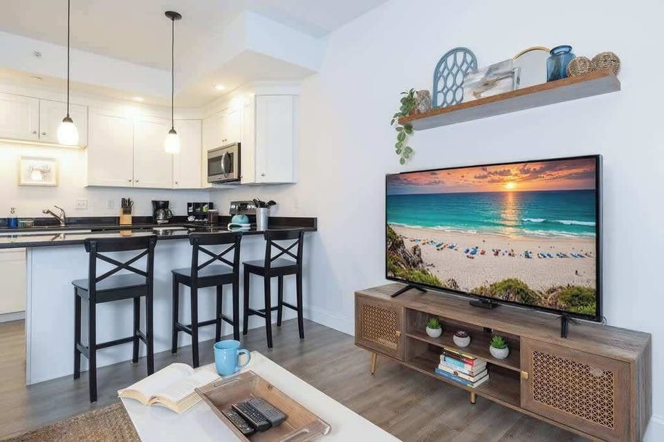 Open concept living space with flat screen TV