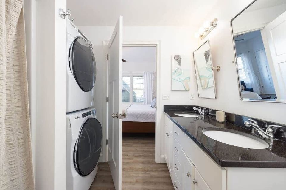 Master bath boasts double vanity with complimentary towels and soaps.