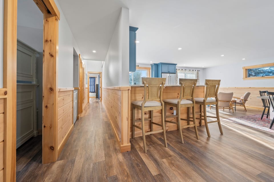 Kitchen with island seating and hallway to bedrooms
