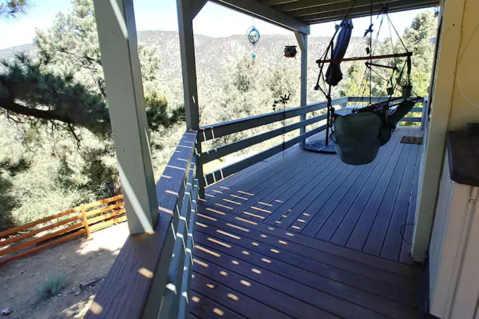 Hammock chairs on the deck leading to the sliding door entrance. 