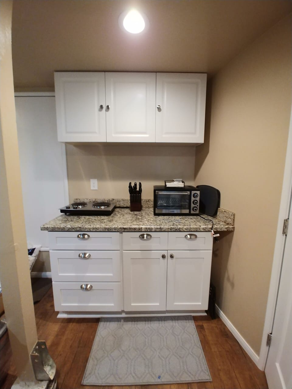 Toaster oven, hot plate and cooking area. Pots, pans, dishes, utensils, etc