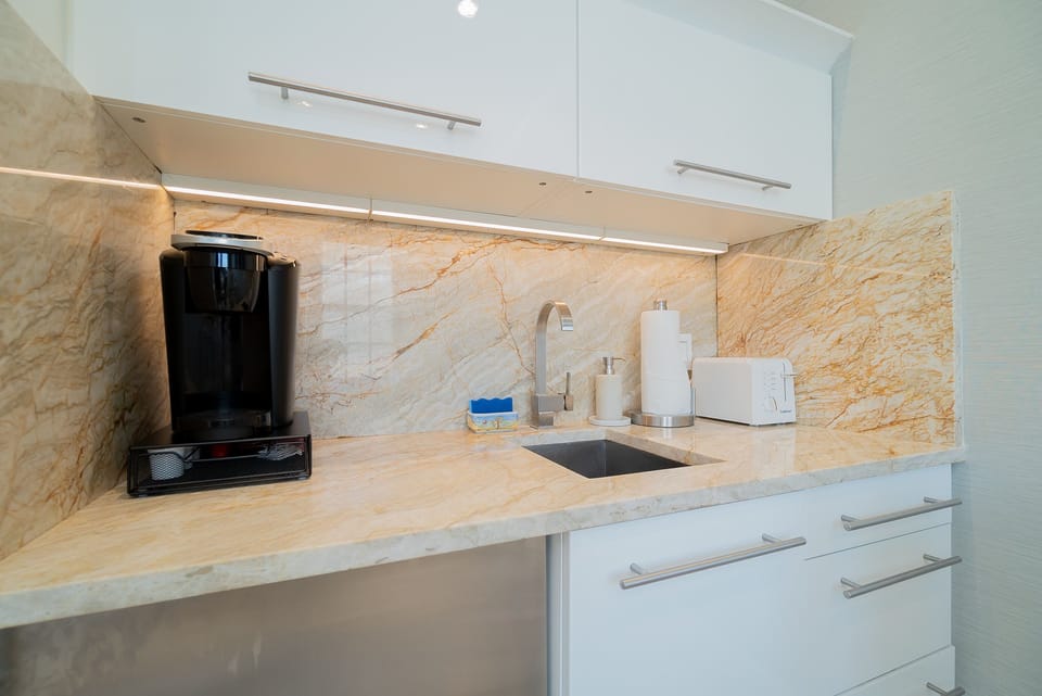 Kitchen w/lighted drawers, microwave, toaster, coffee maker & fridge.