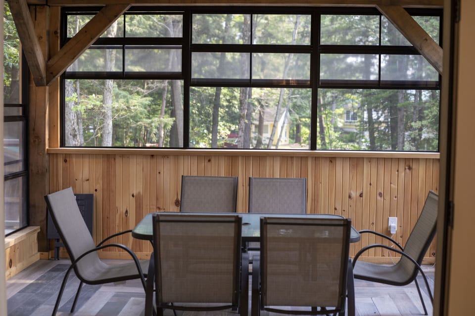 Muskoka Room overlooks the driveway.  Fully screened with 6 person kitchen table