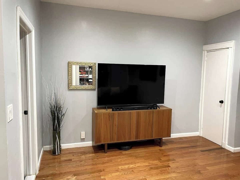 Living room featuring 65" 4K UHD Samsung Smart TV