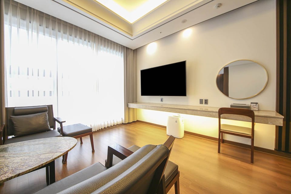Junior Family Suite | Living area | 64-inch LED TV with cable channels, TV, Netflix