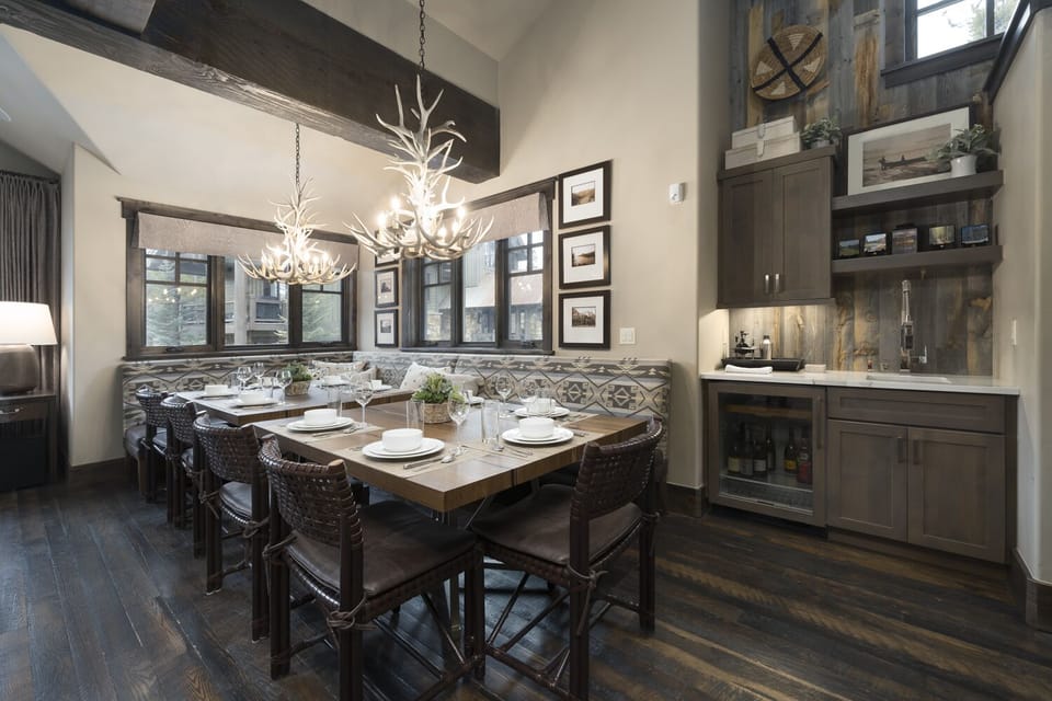 Enjoy dinner under the antler chandeliers at the spacious dining table