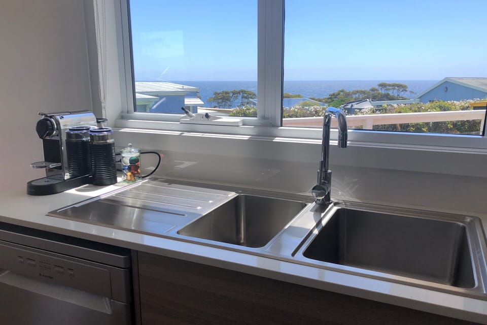 Kitchen has double sink - water views