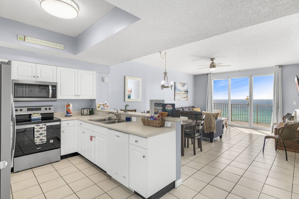Kitchen with stainless appliances. Fully stocked with coffee/tea bar, oils/spices, Tupperware, pots/pans/cookware. You can prepare delicious meals while overlooking the Gulf of Mexico!