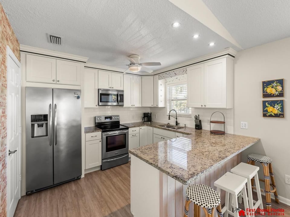 Modern kitchen with granite island and stainless steel appliances