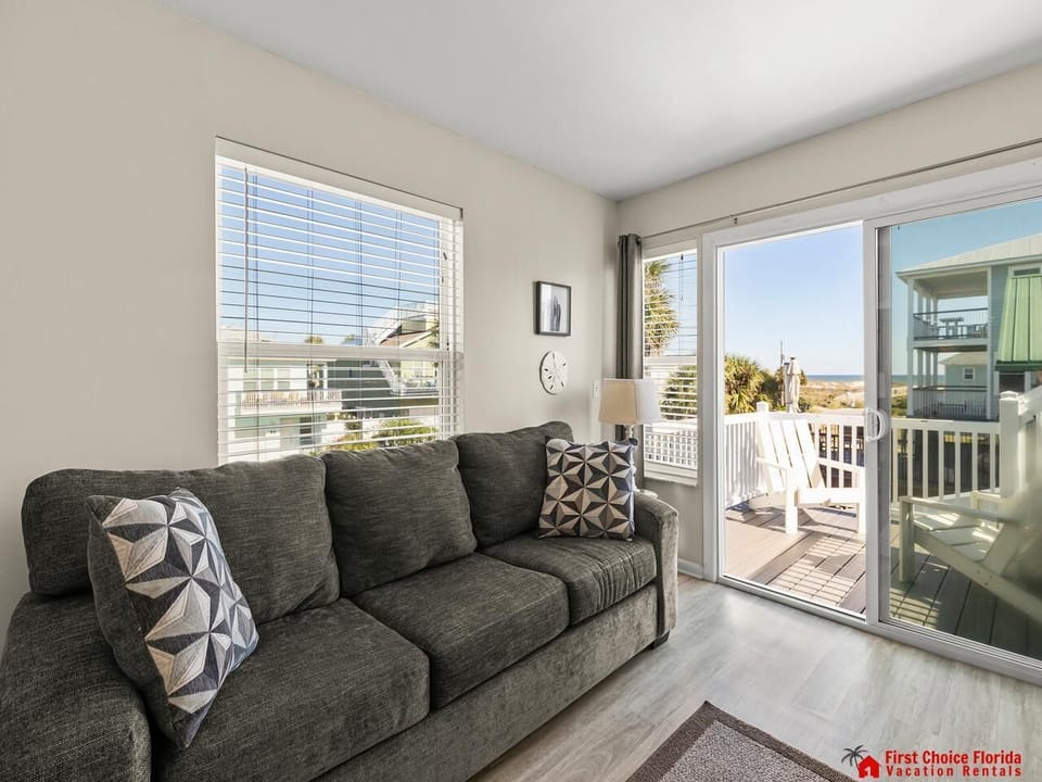 Cozy living room with bright natural light and balcony access