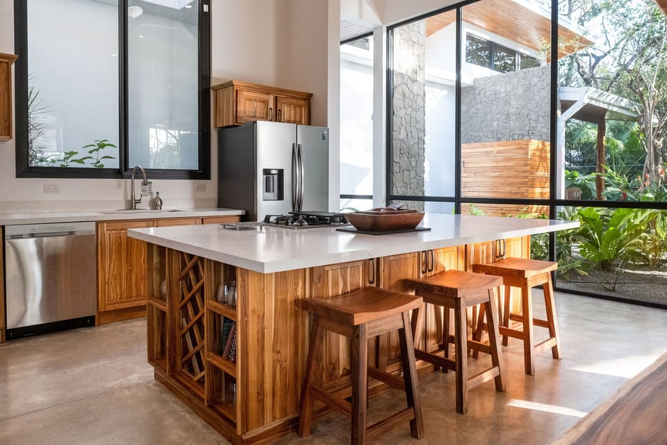 Bright and open kitchen with top end appliances and utensils.