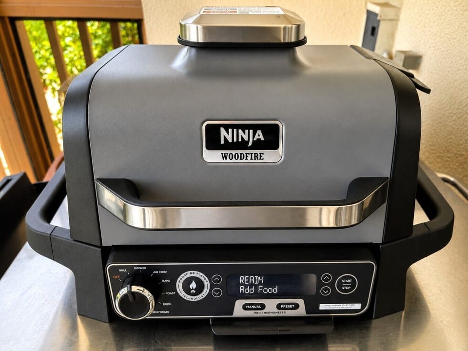 Screened lanai with Ninja Woodfire grill — perfect for easy outdoor meals.