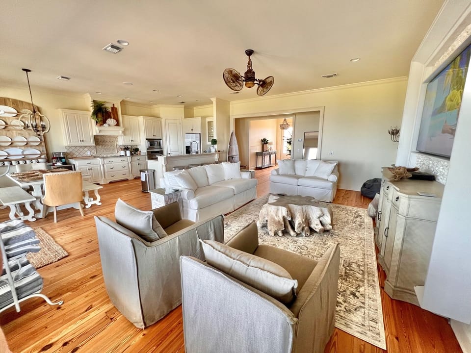 Comfortable seating in light, sunny, water view great room. 
