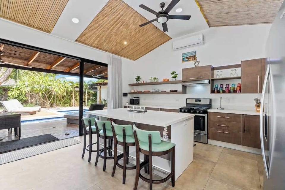 Open kitchen with island seating and outdoor access