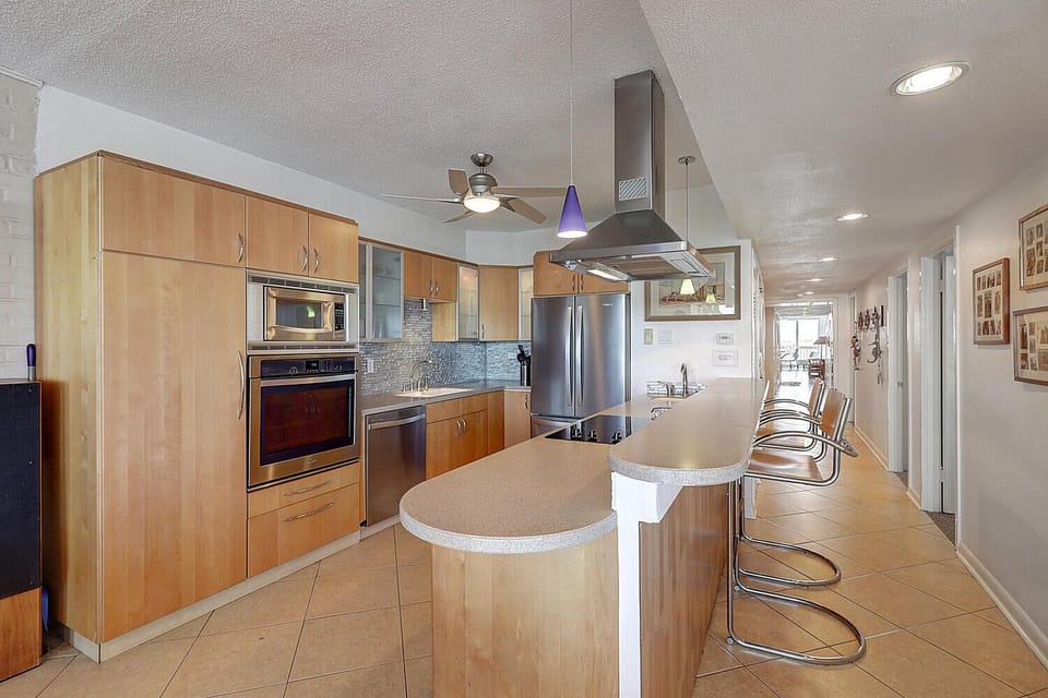 Your modern kitchen features sleek wood cabinets, granite counters, and premium stainless appliances perfect for culinary adventures.