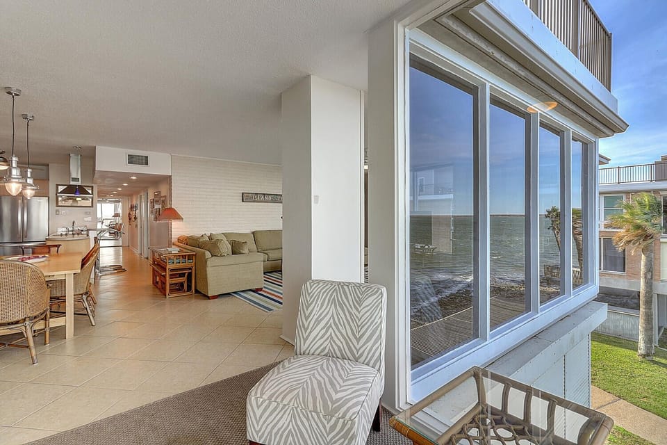 Relax in your bright, open living space with stunning ocean views through floor-to-ceiling windows that flood the room with natural light.