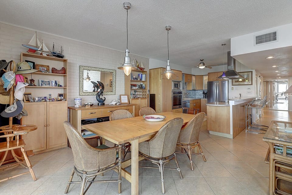 Your spacious open-plan kitchen and dining area features warm wood cabinets, modern appliances, and nautical touches for memorable family meals.