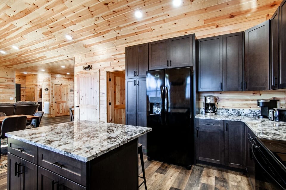 Elegant kitchen with granite countertops, modern appliances, and charm.