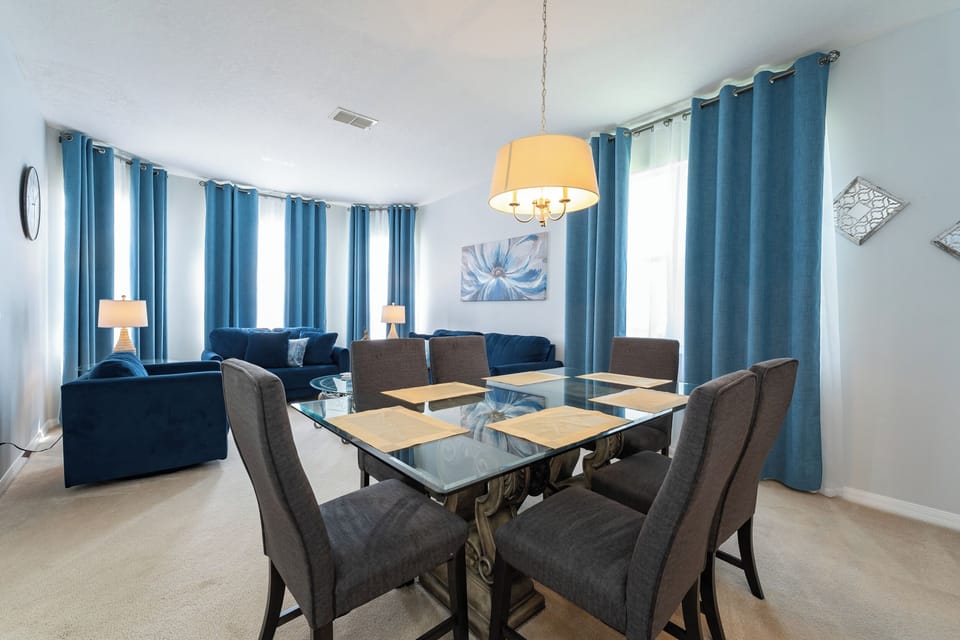 Dining area with seating for six and adjacent living space.