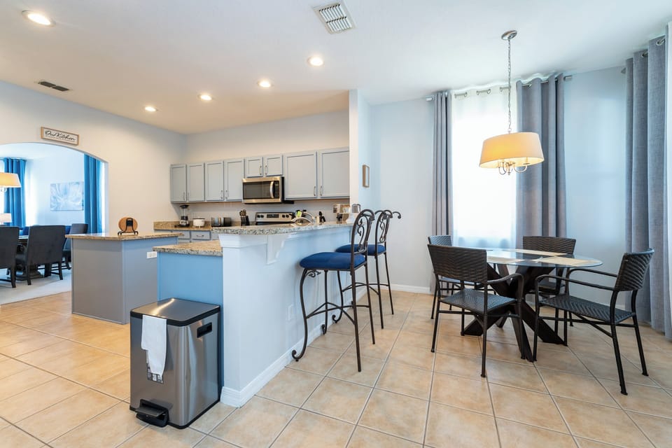 Open plan kitchen and dining area with breakfast bar seating.