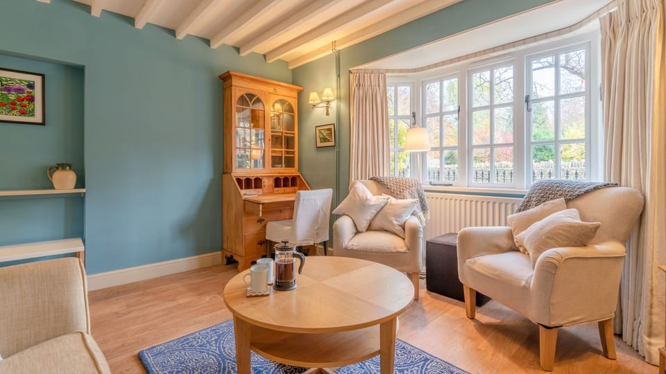 The spacious master bedroom has a king-size bed, Manor Lodge Cottage.