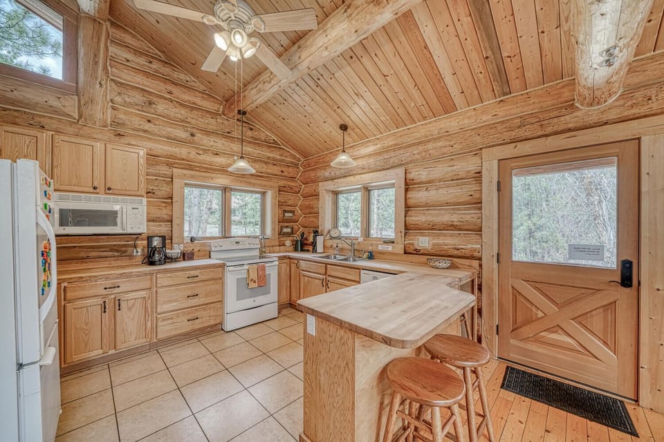 Fully-appointed kitchen with bar seating.
