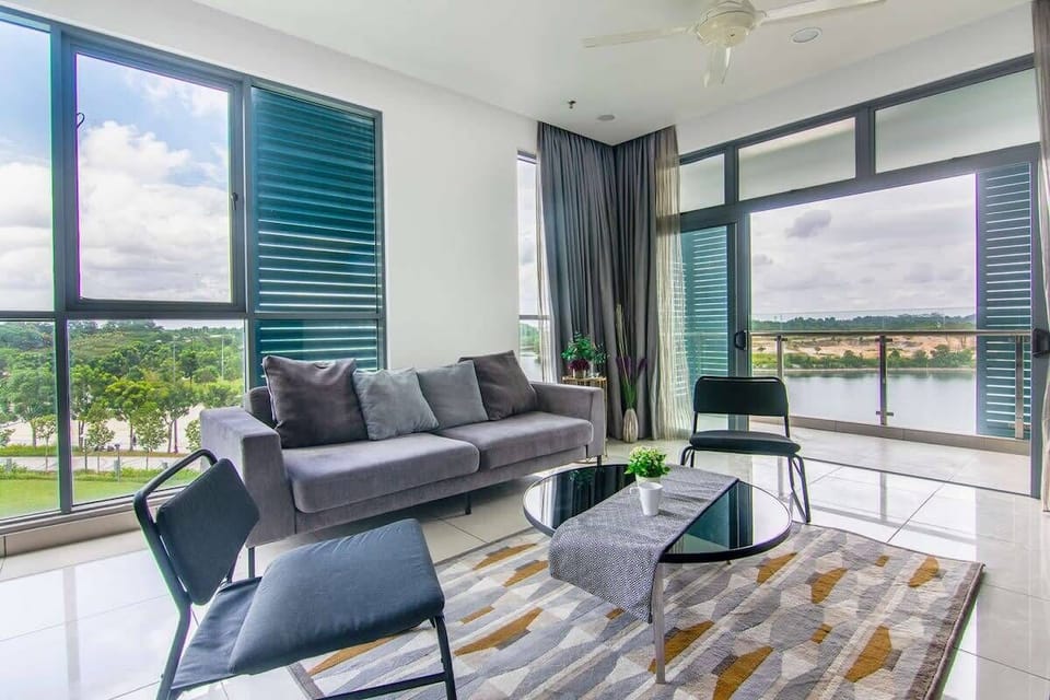 The bright & airy living area with a two-seater sofa and two chairs.