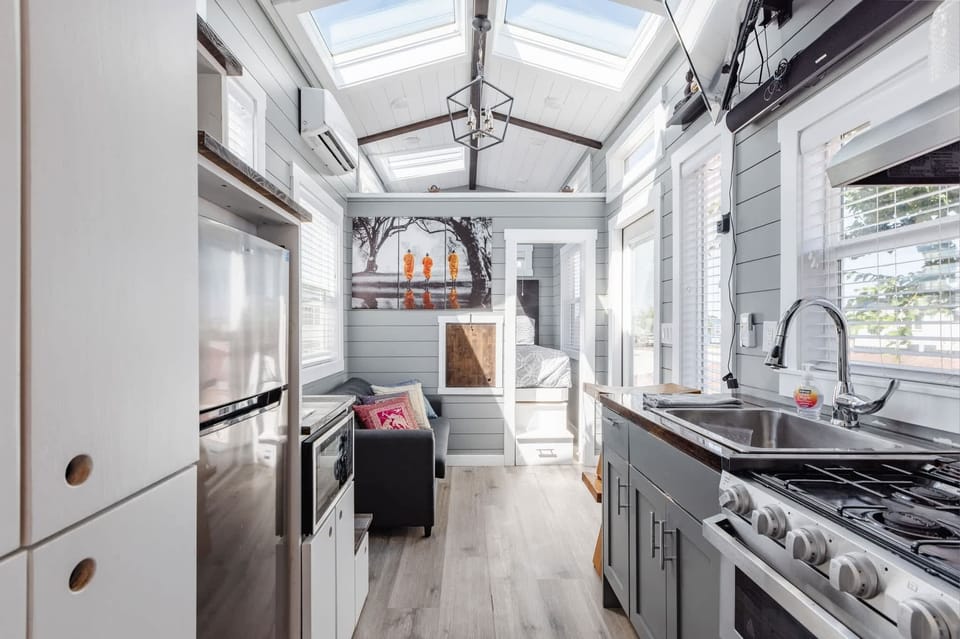 Kitchen fully equipped with a refrigerator, freezer, microwave, stove, oven and sink with hot/cold water. Enjoy coffee from the coffee maker and ample counter space. Essentials include cookware, dishes, utensils, and plenty of storage cabinets.